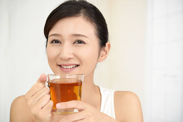 istock Woman drinking a glass of tea 635796874