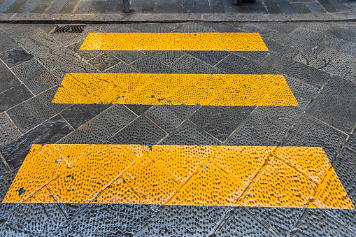 yellow stripes crosswalk across the street