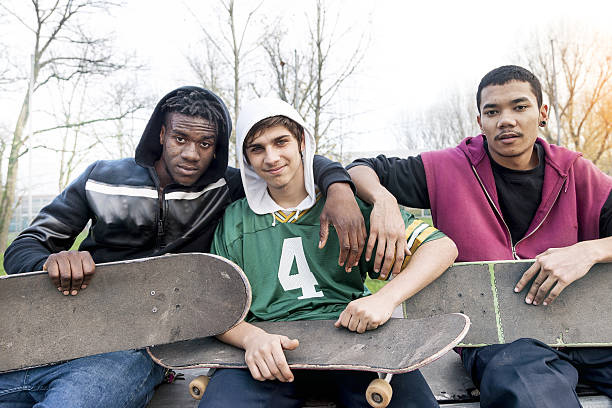 istock group of young adults sitting on a ramp with skateboard 635799544