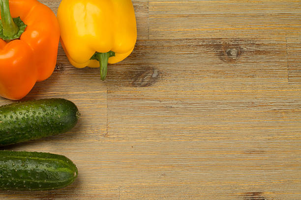 istock Vegetables on wooden table background around the side. Cucumbers, cutting 635802054