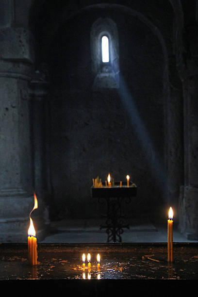 istock Window light and candles light the Haghardsin Monastery 635806690