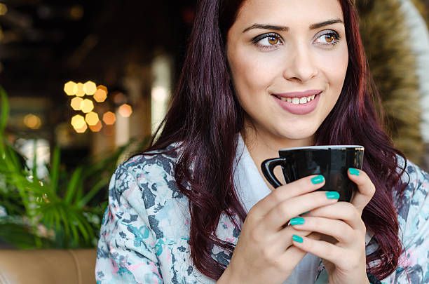portrait of a beautiful teenage girl with coffee portrait of a beautiful teenage girl with coffee in hand close up. Hold the cup in his hand and looking sideways with space for text. purple hair stock pictures, royalty-free photos & images