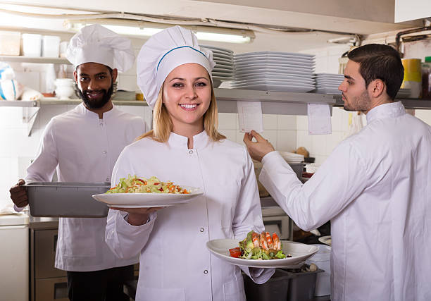 istock Crew of professional cooks working at restaurant 635811338