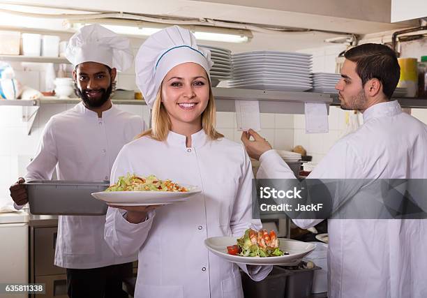 Crew Of Professional Cooks Working At Restaurant Stock Photo - Download Image Now - Cafeteria, Chef, Preparing Food