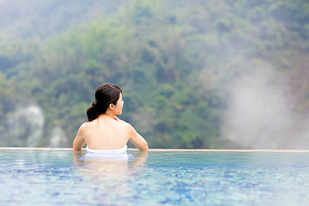 istock young woman relaxing in  hot springs 635811466