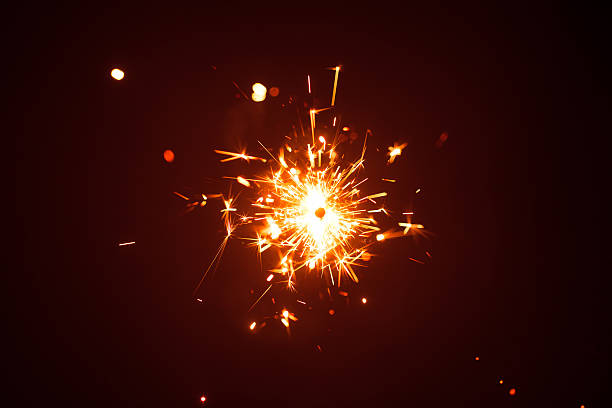 istock Christmas sparkler in haze with red light 635811520