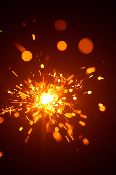 istock Christmas sparkler in haze with red light 635811584