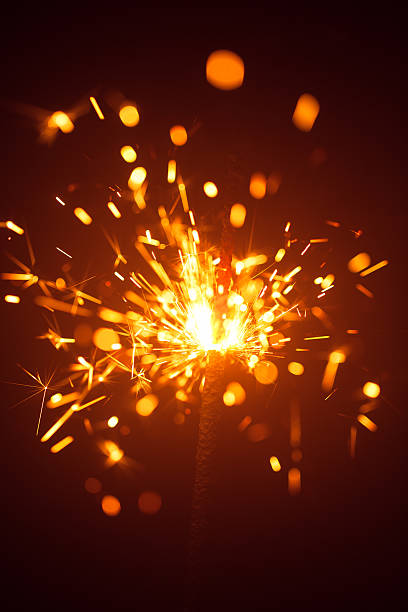istock Christmas sparkler in haze with red light 635811608