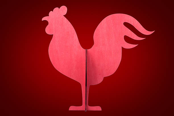 istock Wooden rooster isolated on red background 635811960