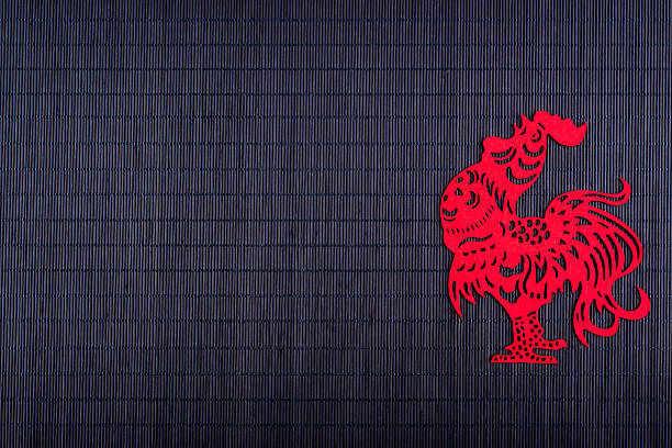 Silhouette of rooster on black bamboo mat, copy space, Chinese New Year 2017 symbol