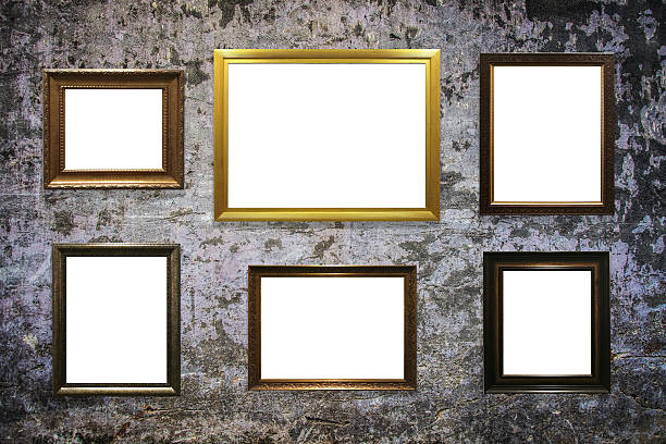 istock wooden picture frame on old wall background 635812396