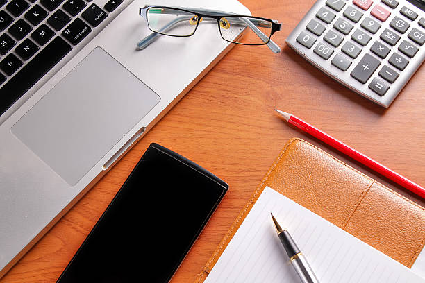 istock Office workplace with laptop and smart phone on wood table 635820588
