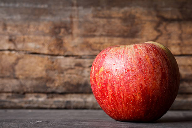 istock single ripe apples on wooden background ,Red Apple fresh 635821544
