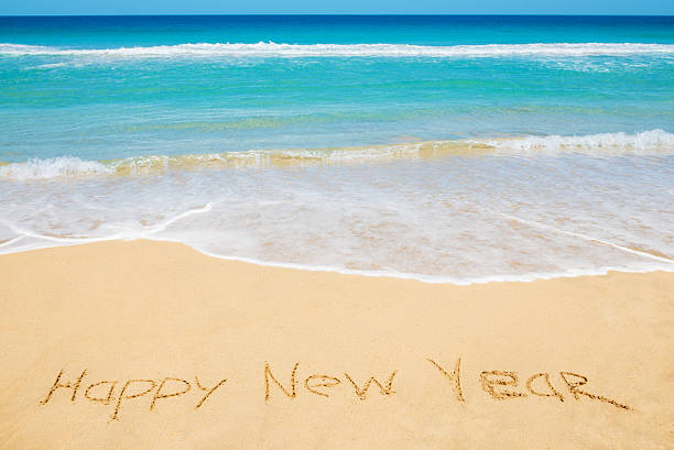 istock Happy New Year message on the beach 635824690