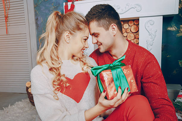 istock loving couple decorating Christmas tree 635828420