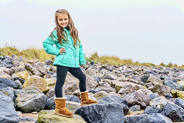 Eight year old girl in winter seashore countryside setting