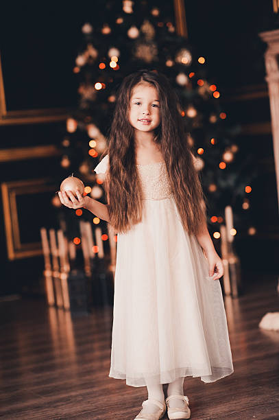 istock Beautiful child decorating Christmas tree 635828712