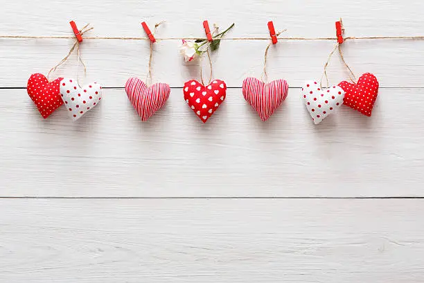 Photo of Valentine day background, pillow hearts border on wood, copy space