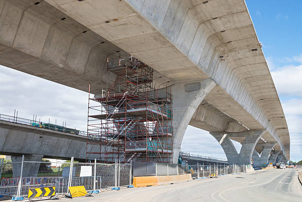 strada sotto ricostruzione - construction bridge below concrete foto e immagini stock