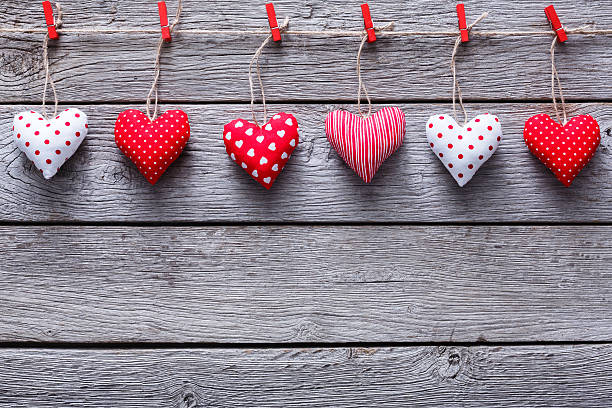 istock Valentine day background, pillow hearts border on wood, copy space 635828972