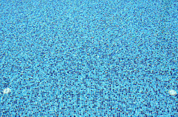 istock Water ripples on blue tiled swimming pool background 635830984