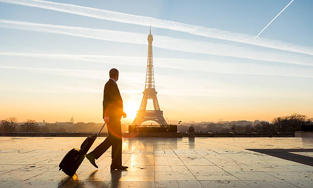 travel businessman walking with suitcase at eiffel tower in paris - business class imagens e fotografias de stock