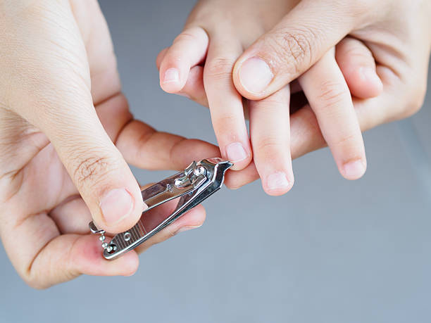 istock Mother hand cut nails for kid by using nail clipper 635837574