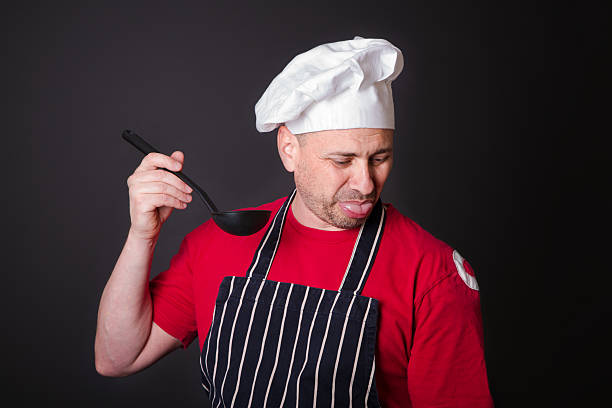 ritratto del cuoco scontento con un mescola nel suo - silverware food and drink industry food service occupation dinner foto e immagini stock