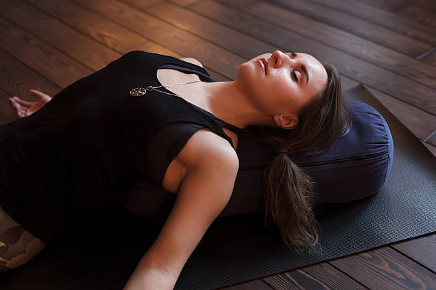 Girl relaxing after a yoga class stock photo