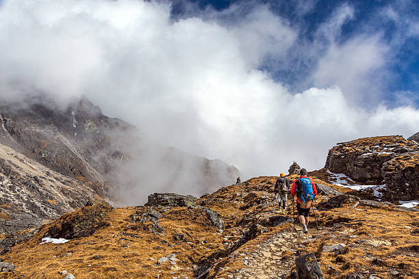 istock Mountain Hikers walking on grassy Terrain beautiful Clouds 635840510