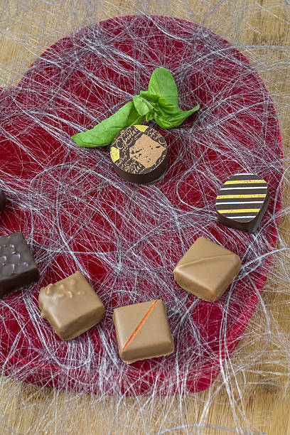 istock Several chocolate candies on the red heart 635840520