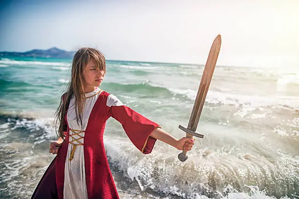 Photo of Young viking shieldmaiden practicing with sword