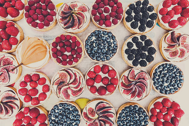 istock Fruit and Berry tarts dessert assorted top view background 635846190