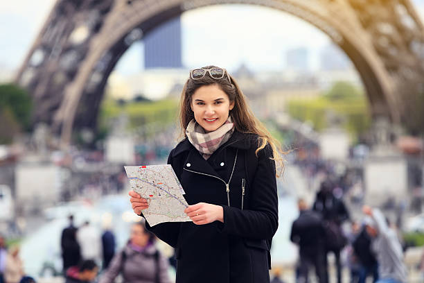 istock Tourist women in Paris holding a map 635848232