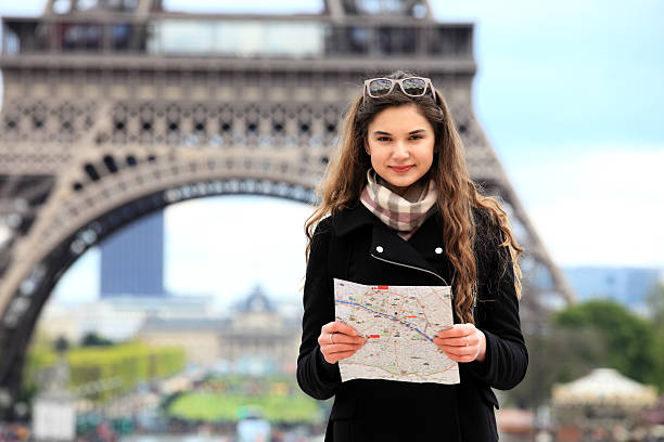 istock Tourist women in Paris holding a map 635848342