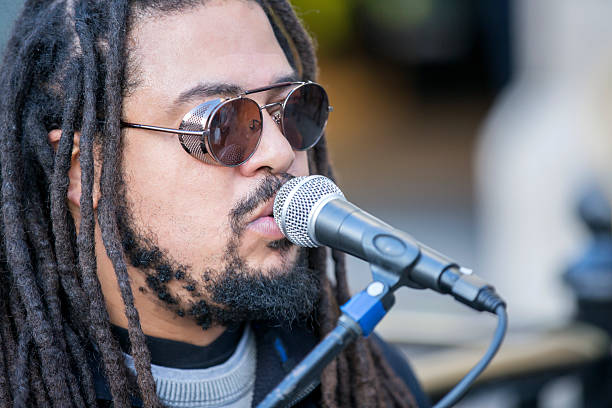 istock Cool singer with dreadlocks in front of mike 635848810