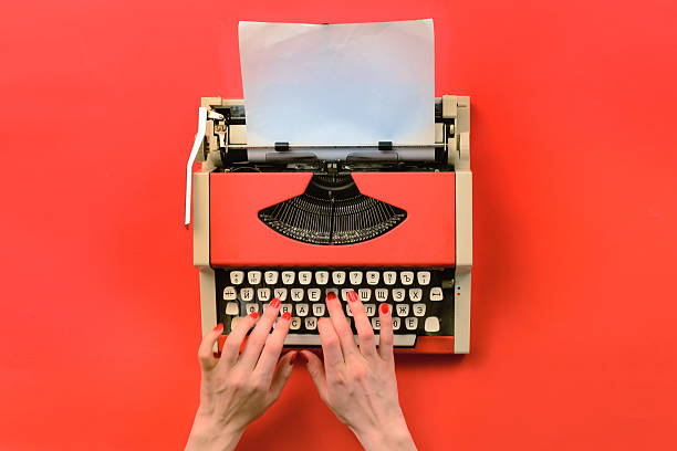 istock Red vintage typewriter with white blank paper sheet 635849516