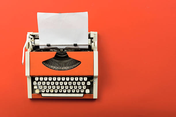 Red vintage typewriter with white blank paper sheet Top view of red vintage typewriter with white blank paper sheet on table typewriter photos stock pictures, royalty-free photos & images