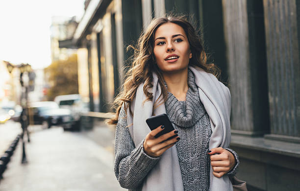 istock Woman texting outdoors 635863338