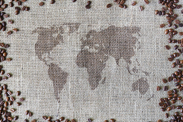 istock Burlap texture with coffee beans border and world map 635863692