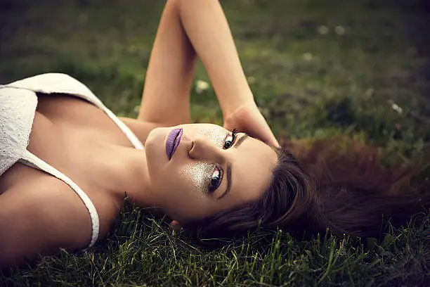 Beautiful young woman relaxing in park