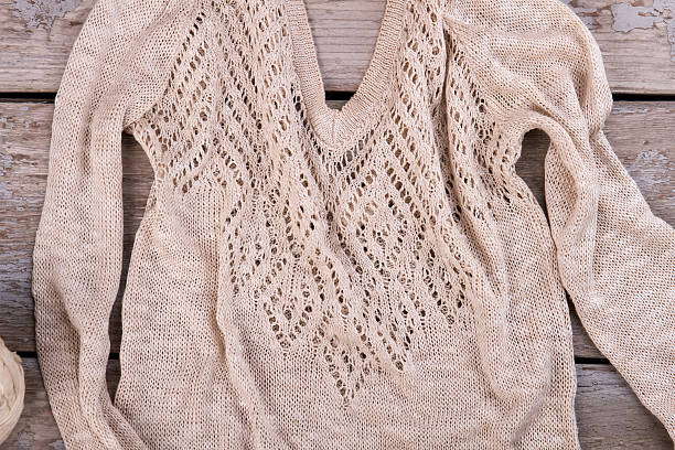 istock Beautiful knitted blouse with openwork neckline. 635864542
