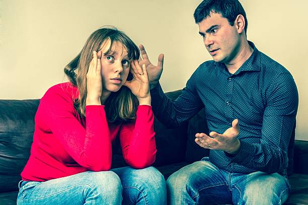 istock Young couple into an argument in living room 635866008