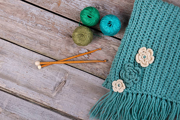 istock Knitted scarf with handmade flowers. 635866016