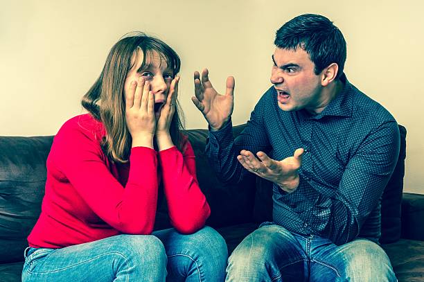 istock Young couple into an argument in living room 635866206