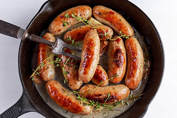 istock Home-made Pork Sausages in rustic pan with thyme 635866316