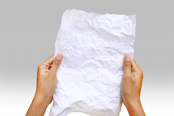 istock Woman hands holding square crumpled paper against gray gradient background. 635869242