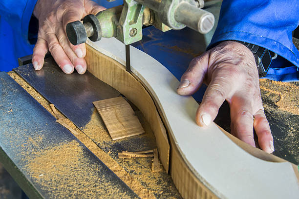 istock Carpenter workplace. Man using saw to cut wood 635869840