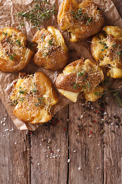 istock crash hot potatoes with thyme close-up. Vertical top view 635870890