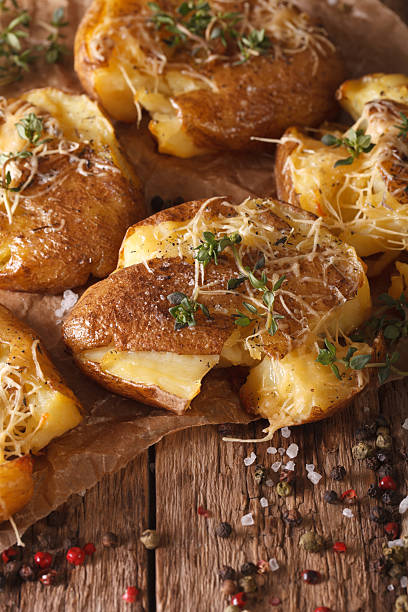 istock Australian baked crash hot potatoes with thyme close-up. Vertical 635871346